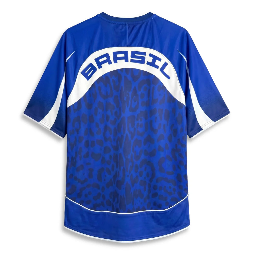 A Varldens royal blue short-sleeve jersey with a dark blue leopard print pattern on the back, featuring a white arched panel with the word 'BRASIL' in blue letters. The sleeves and shoulders have white side panels.