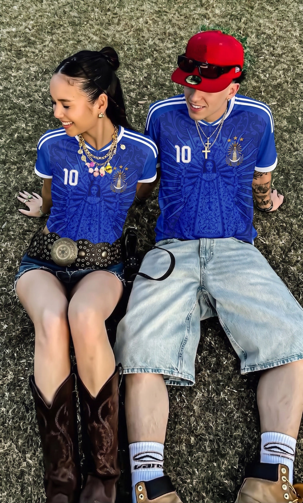 Couple wearing Varldens Argentina 1986 champion blue jersey with Virgen de Luján and Fileteado art - Retro soccer streetwear fashion