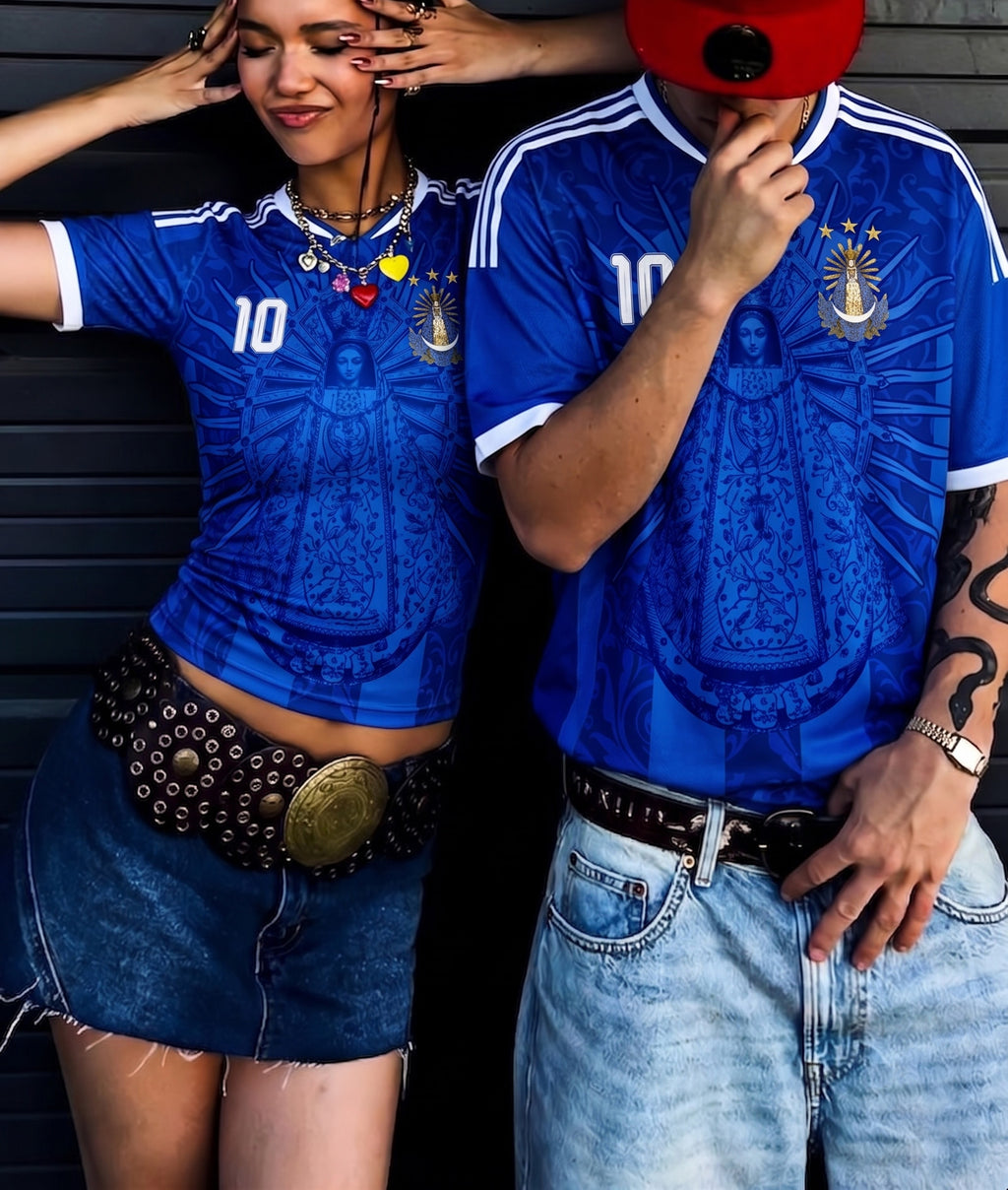 Couple wearing Varldens Argentina 1986 champion blue jersey with Virgen de Luján and Fileteado art - Retro soccer streetwear fashion