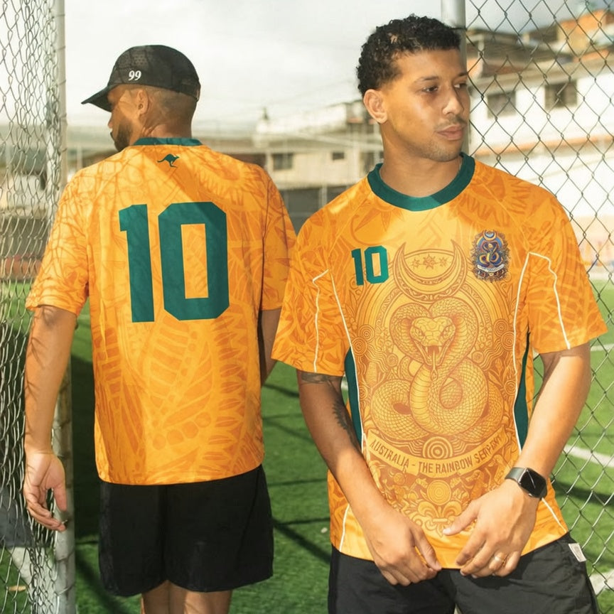 Front and back view of Australia 2026 home jersey in gold and green with Rainbow Serpent and Aboriginal tribal motifs
