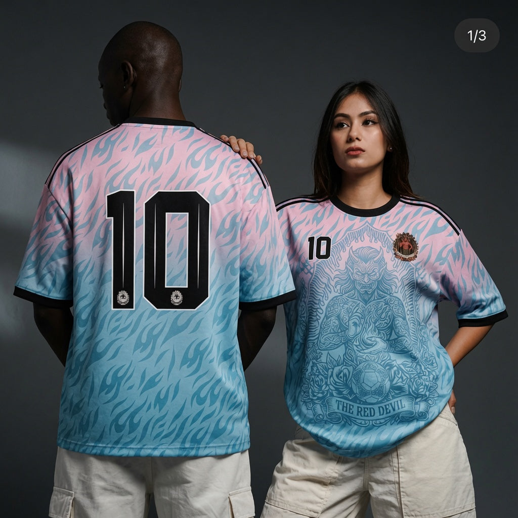 Front and back view of Belgium 2026 away jersey in pink and blue gradient with The Red Devil and sublimated flame motifs