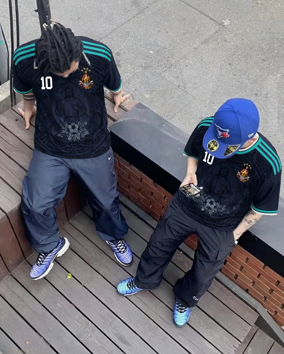 Front and back view of Germany 2026 away jersey in midnight navy with Jesus Christ graphics and teal striped trims