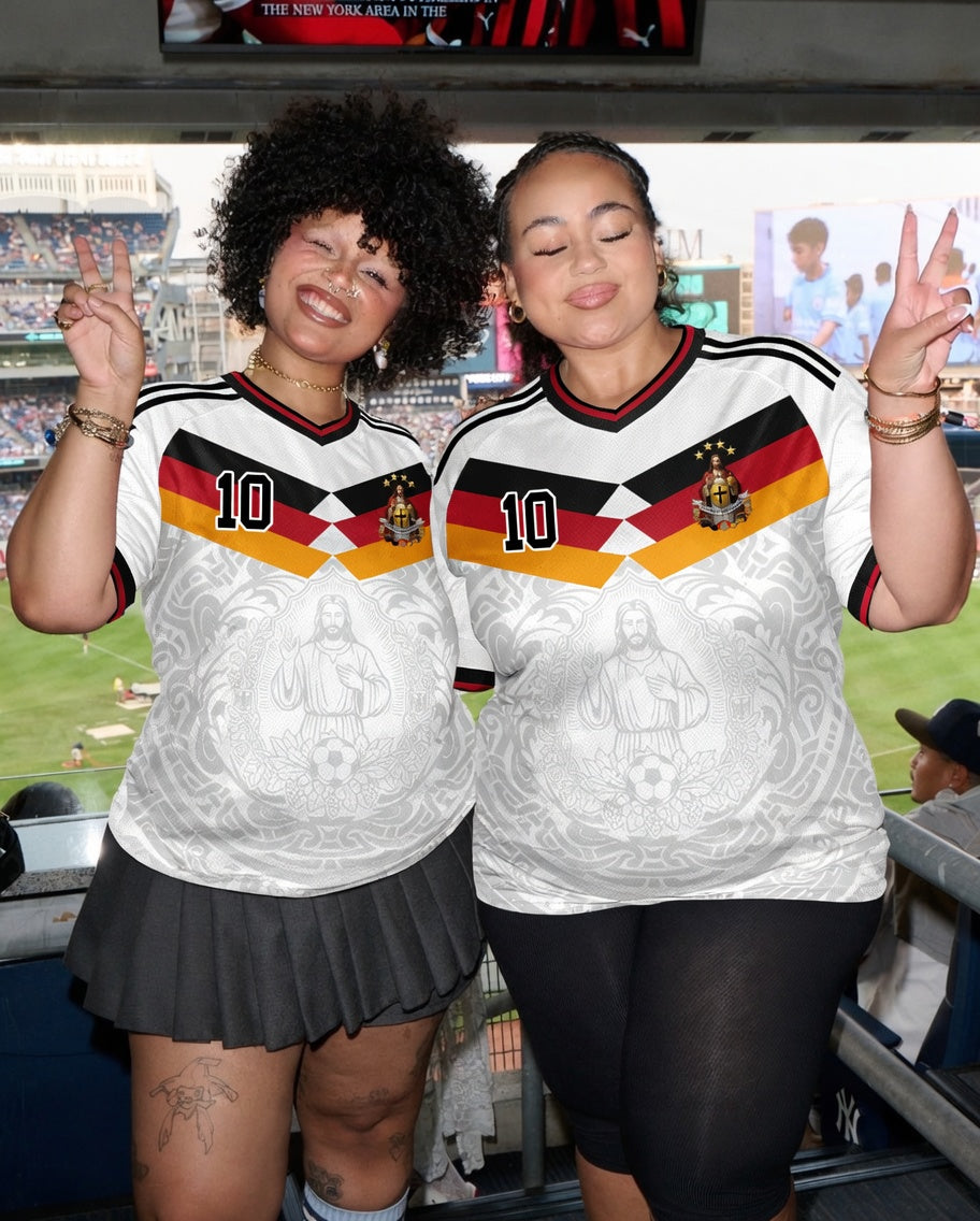 Front and back view of Germany 2026 home jersey in white with Jesus Christ graphics and German tricolor chevron stripes