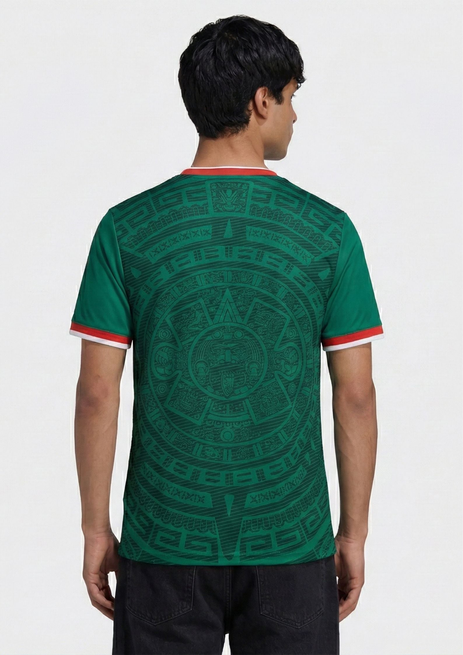 Front and back view of Mexico 2026 home jersey in emerald green with intricate Aztec calendar stone patterns