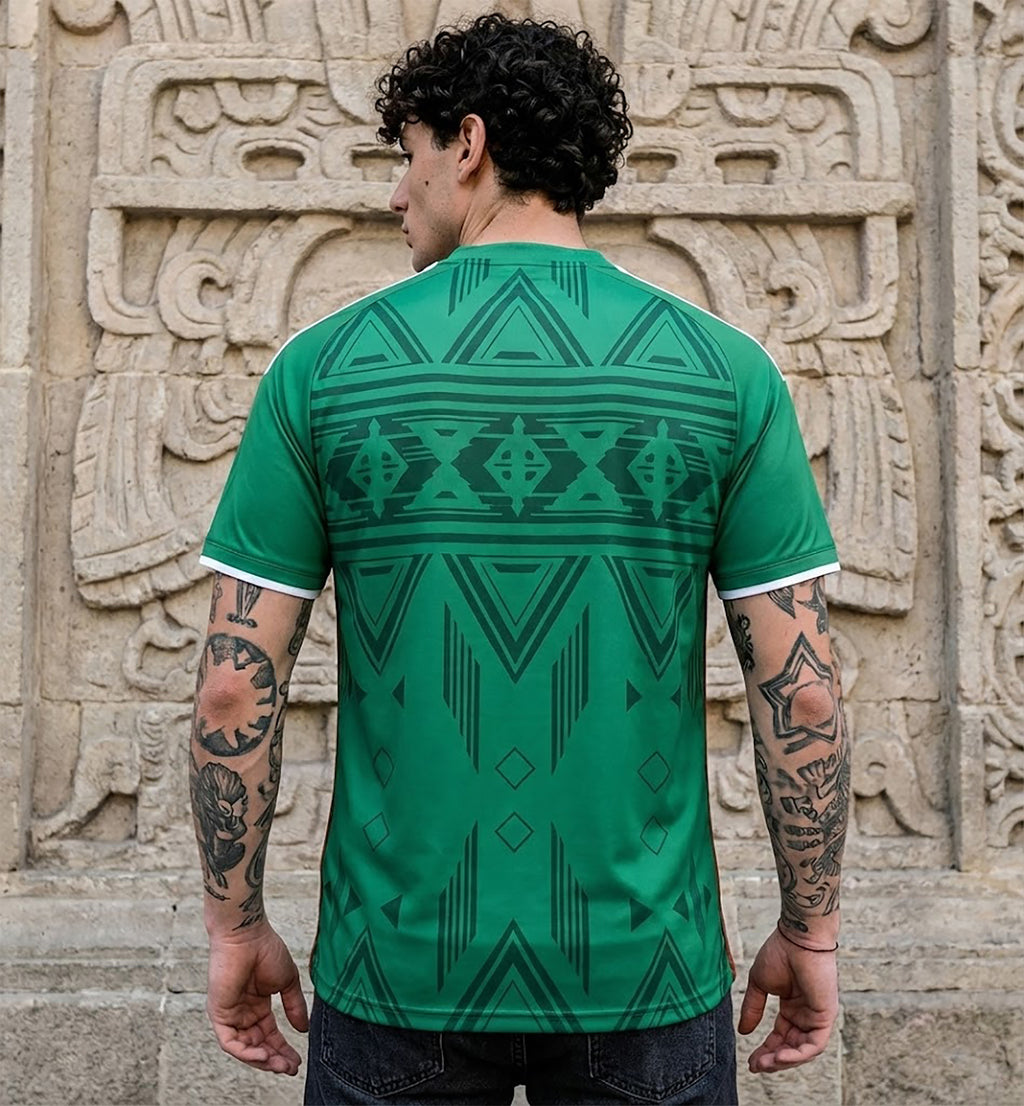 Front and back view of Mexico 2026 home jersey in green with Aztec geometric tribal patterns on display mannequin