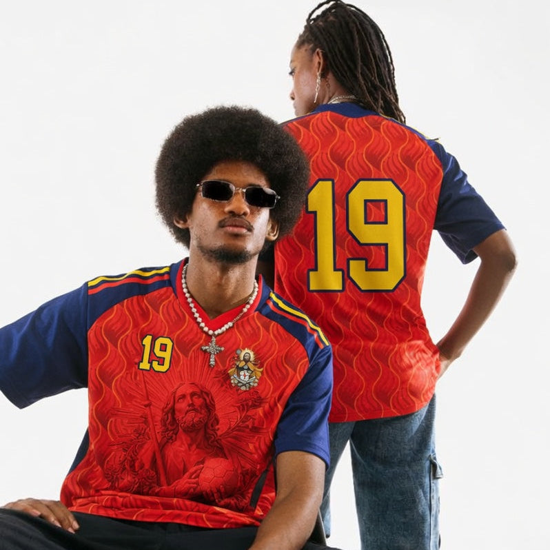 Front and back view of Spain 2026 home jersey in red and navy with Saint James graphics and sublimated flame patterns
