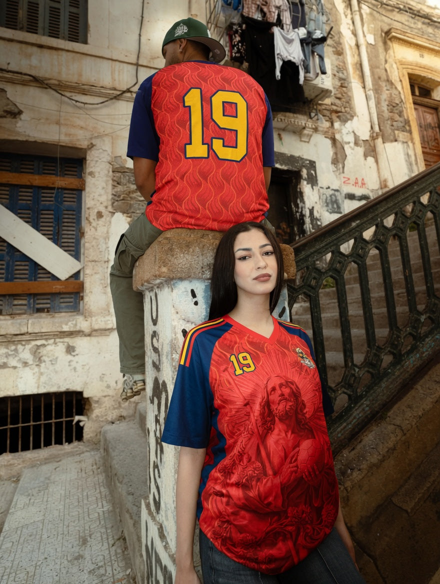 Front and back view of Spain 2026 home jersey in red and navy with Saint James graphics and sublimated flame patterns