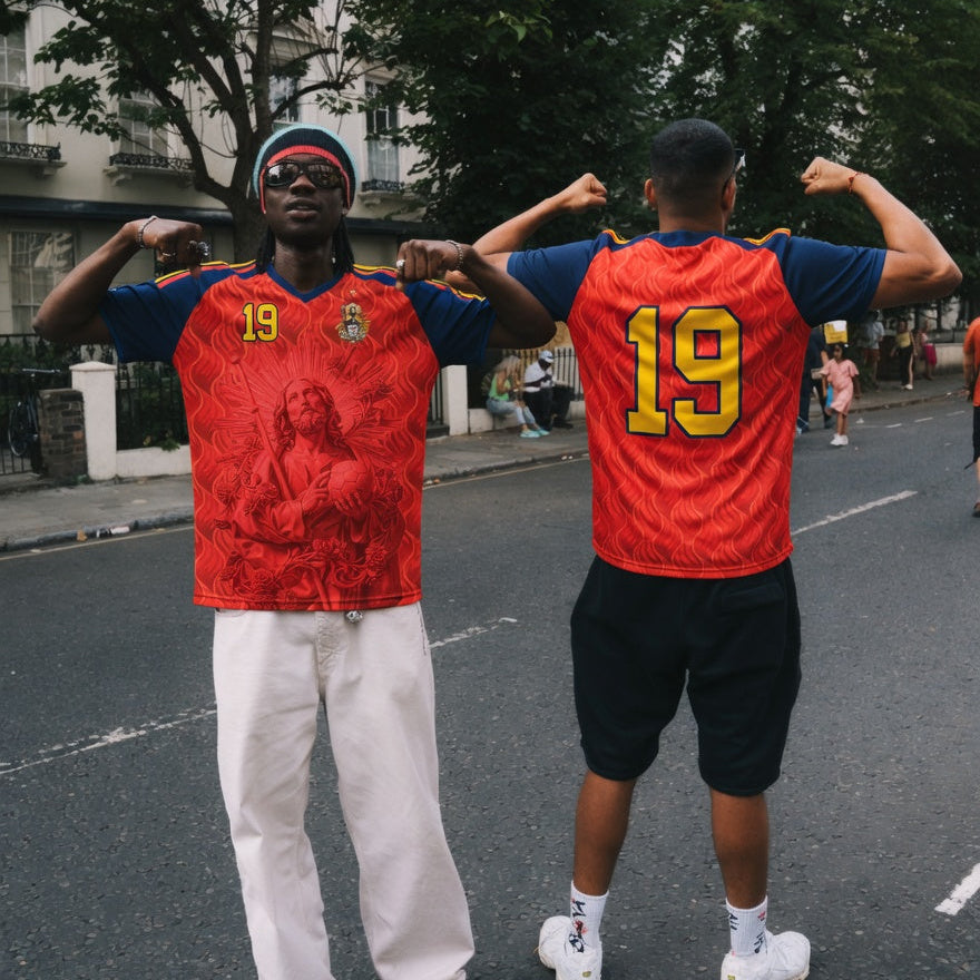 Front and back view of Spain 2026 home jersey in red and navy with Saint James graphics and sublimated flame patterns