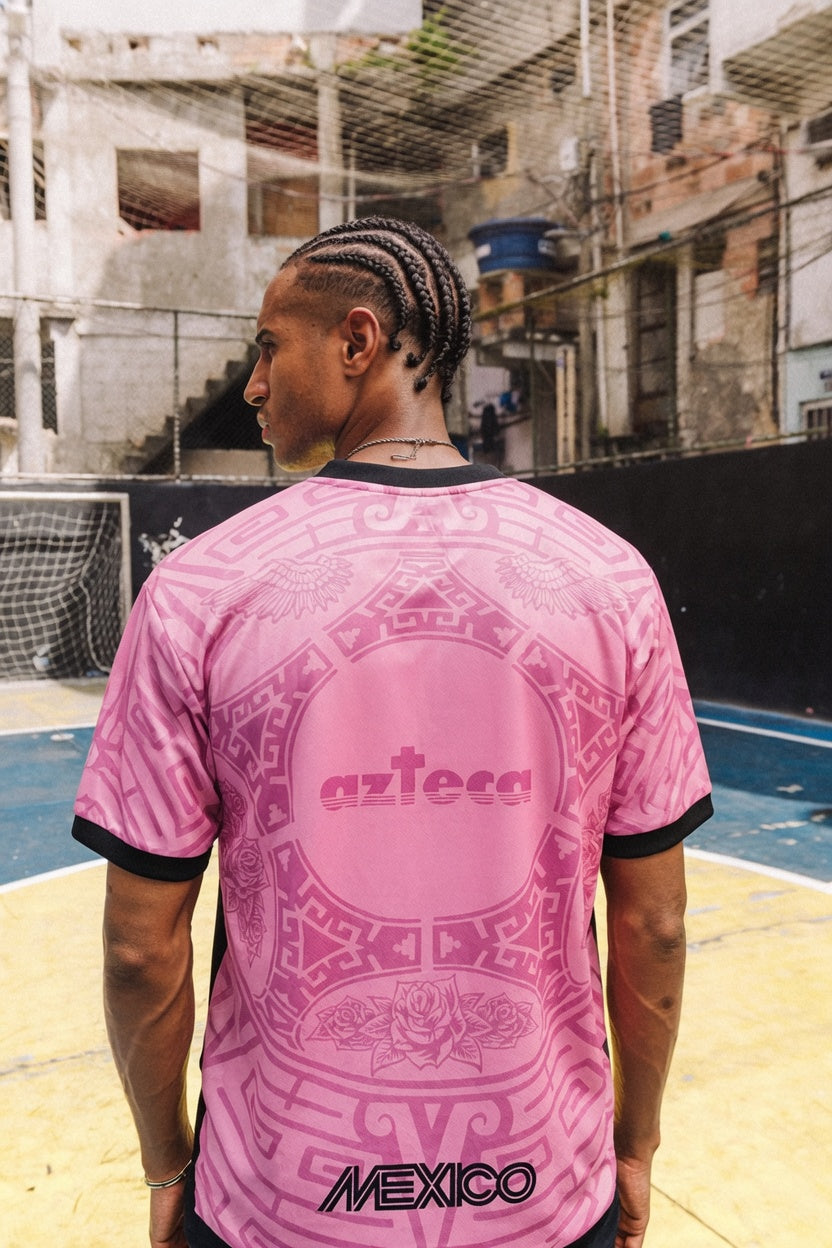 Man styling Varldens pink Mexico football shirt with Our Lady of Guadalupe art and azteca back print for a Blokecore streetwear look